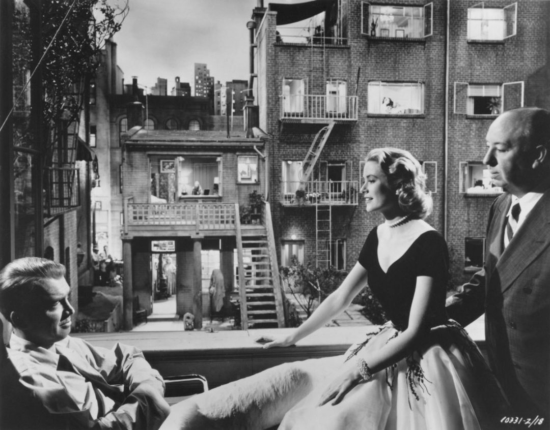 James Stewart, Grace Kelly, and Alfred Hitchcock on the set of REAR WINDOW, 1954
